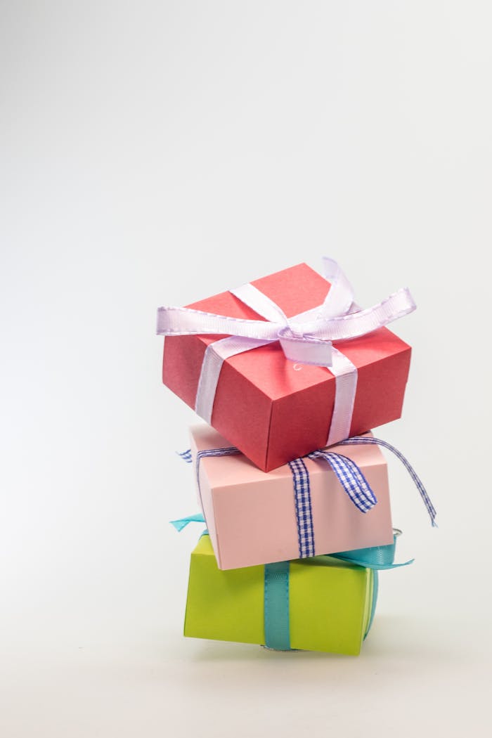 A stack of colorful gift boxes tied with ribbons, perfect for celebrations and festive occasions.
